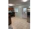 Functional kitchen features tile floors, stainless steel fridge, and a range stove with black countertop space at 1025 Lynwood Pl, Forest Park, GA 30297