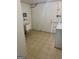 Laundry room with tile floors and white walls featuring a utility sink and a white washing machine at 1025 Lynwood Pl, Forest Park, GA 30297