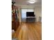Open living area featuring hardwood floors, large TV, hutch, and ornate chandelier at 1025 Lynwood Pl, Forest Park, GA 30297