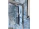 Modern shower featuring adjustable shower head and luxurious blue tiled walls at 1025 Lynwood Pl, Forest Park, GA 30297