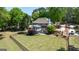 Aerial view of a home with a large backyard, stone firepit, and fence, showcasing outdoor living spaces at 513 Viridian Vw, Peachtree City, GA 30269