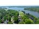 Aerial view of golf course community home on the lake with mature trees at 513 Viridian Vw, Peachtree City, GA 30269