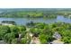 Expansive aerial view of luxury homes surrounded by lush trees and a serene lake for tranquil living at 513 Viridian Vw, Peachtree City, GA 30269