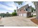 Rear view of home with three-car garage, and beautiful lake views at 513 Viridian Vw, Peachtree City, GA 30269