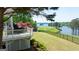 Backyard view featuring a deck with a grill, green grass, and a glimpse of the lake at 513 Viridian Vw, Peachtree City, GA 30269