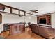 Featuring a fully-equipped bar area and a cozy recreation area with hardwood flooring and a ceiling fan at 513 Viridian Vw, Peachtree City, GA 30269