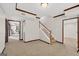 Open-concept basement area showcasing stairs, carpet flooring, wood trim, and paneled doorways at 513 Viridian Vw, Peachtree City, GA 30269