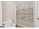 A full bathroom features a toilet, shower with curtain, and storage for towels at 513 Viridian Vw, Peachtree City, GA 30269
