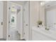 Bathroom doorway view with tile floors and white vanity, sink, mirror, and fixtures at 513 Viridian Vw, Peachtree City, GA 30269