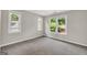 Bedroom with carpet and three windows overlooking outdoor greenery at 513 Viridian Vw, Peachtree City, GA 30269