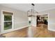 Spacious dining area boasts hardwood floors, modern lighting, and views of the lush backyard at 513 Viridian Vw, Peachtree City, GA 30269
