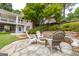 Stone firepit with seating offers a cozy outdoor space with lake views, enhancing the backyard's appeal at 513 Viridian Vw, Peachtree City, GA 30269