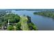 Beautiful aerial view showcasing the well-manicured golf course with serene lake frontage and natural landscaping at 513 Viridian Vw, Peachtree City, GA 30269