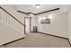 A large hallway with carpet flooring, staircase, and neutral walls offers a blank canvas at 513 Viridian Vw, Peachtree City, GA 30269