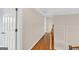 Hallway with hardwood floors and white doors, trimmed walls and banister at 513 Viridian Vw, Peachtree City, GA 30269