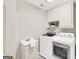This laundry room includes a sink, washer, dryer, and plenty of storage at 513 Viridian Vw, Peachtree City, GA 30269