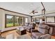 A spacious living room boasts natural light with views of the lake, a bar, and a pool table at 513 Viridian Vw, Peachtree City, GA 30269