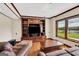 Cozy living room features custom built-ins, hardwood floors, and a window with scenic outside views at 513 Viridian Vw, Peachtree City, GA 30269