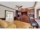 Office features custom cabinetry, hardwood floors, and a comfortable seating area at 513 Viridian Vw, Peachtree City, GA 30269