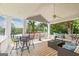 Covered patio features seating area with a table, sofa, and scenic lake views at 513 Viridian Vw, Peachtree City, GA 30269