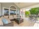 Spacious covered porch with comfortable seating, overlooking lush greenery and mature trees at 513 Viridian Vw, Peachtree City, GA 30269