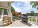Outdoor deck with stainless steel grill and golf course and lake views at 513 Viridian Vw, Peachtree City, GA 30269