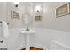 Traditional powder room with pedestal sink, wainscoting and decorative lighting at 513 Viridian Vw, Peachtree City, GA 30269