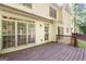 Backyard showing a deck with exterior home view that features large sliding glass doors and wooden railing at 2402 Creekside Trce, Jonesboro, GA 30236