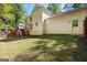 The backyard features a grassy lawn, a wooden deck, and access to the home at 2402 Creekside Trce, Jonesboro, GA 30236