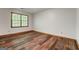 Empty bedroom featuring wood-look flooring, neutral walls, and a window providing natural light at 2402 Creekside Trce, Jonesboro, GA 30236