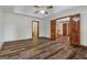 The spacious bedroom has wood floors, a ceiling fan, plus access to the bath and hallway at 2402 Creekside Trce, Jonesboro, GA 30236