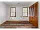 This bedroom offers hardwood style floors, two windows with blinds, and a closet at 2402 Creekside Trce, Jonesboro, GA 30236