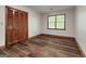 Bedroom with wood floors, a window for natural light, and a closet for storage at 2402 Creekside Trce, Jonesboro, GA 30236