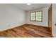 Bedroom featuring wood-look flooring, neutral walls, and a window for natural light at 2402 Creekside Trce, Jonesboro, GA 30236