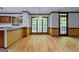 Bright dining area with large windows offering views, hardwood floors, and access to an outdoor space at 2402 Creekside Trce, Jonesboro, GA 30236