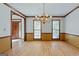 Elegant dining room showcasing a chandelier, hardwood floors, and expansive windows overlooking the outdoors at 2402 Creekside Trce, Jonesboro, GA 30236