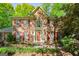 Charming brick home with red shutters, complemented by mature landscaping and a welcoming entrance at 2402 Creekside Trce, Jonesboro, GA 30236