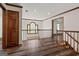 Bright hallway features wood floors, stairs, and a window with transom letting in natural light at 2402 Creekside Trce, Jonesboro, GA 30236