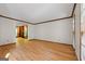 Bright and airy living room with hardwood floors and view to Gathering room with fireplace and built in shelves at 2402 Creekside Trce, Jonesboro, GA 30236