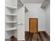 Spacious walk-in closet with built in shelving and wood floors at 2402 Creekside Trce, Jonesboro, GA 30236