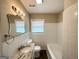 Classic bathroom with a granite countertop vanity, updated fixtures, and a tiled tub at 1962 Marvin Sw Ln, Atlanta, GA 30311