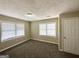 Neutral bedroom featuring plush carpeting, and a large window for natural light at 1962 Marvin Sw Ln, Atlanta, GA 30311