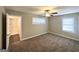 Bedroom features a ceiling fan, carpet, and natural light from two windows at 1962 Marvin Sw Ln, Atlanta, GA 30311