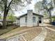 Home with stone chimney, landscaped front yard, and brick walkway at 1962 Marvin Sw Ln, Atlanta, GA 30311