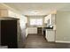 Bright, renovated kitchen boasts granite countertops, white cabinetry, and sleek stainless steel appliances at 1962 Marvin Sw Ln, Atlanta, GA 30311