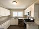 Updated kitchen features granite countertops, white cabinets, and stainless steel appliances at 1962 Marvin Sw Ln, Atlanta, GA 30311