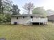 Exterior rear view of a one-story home with a wooden deck and lush green yard at 2965 Meadowview Se Dr, Atlanta, GA 30316