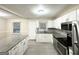 Updated kitchen featuring white cabinets, granite countertops and modern stainless steel appliances at 2965 Meadowview Se Dr, Atlanta, GA 30316