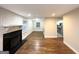 Open-concept living room with a brick fireplace and rich hardwood floors, open to the kitchen at 2965 Meadowview Se Dr, Atlanta, GA 30316