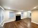 Spacious living area with hardwood floors, flooded with natural light, and a brick fireplace at 2965 Meadowview Se Dr, Atlanta, GA 30316